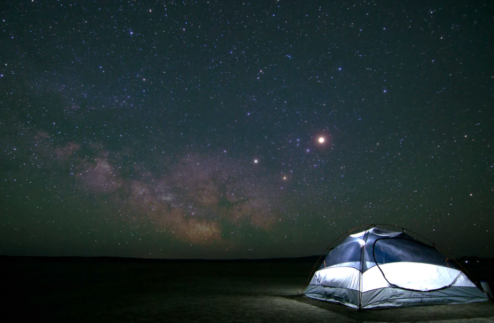 4 person tent under a huge starry sky showing the milky way